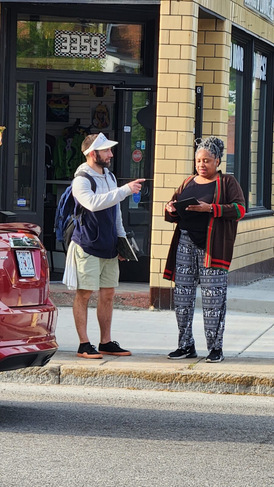 A street team member meeting with a person to get their opinion.