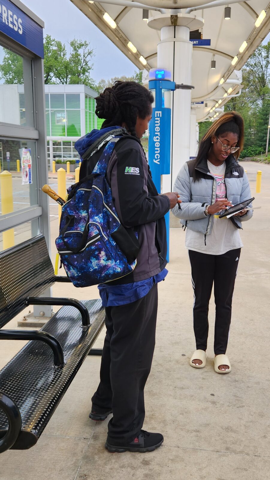 A street team member meeting with a person to get their opinion.