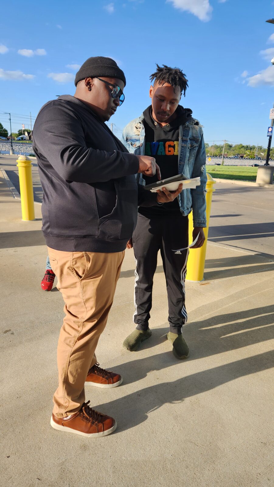 A street team member meeting with a person to get their opinion.