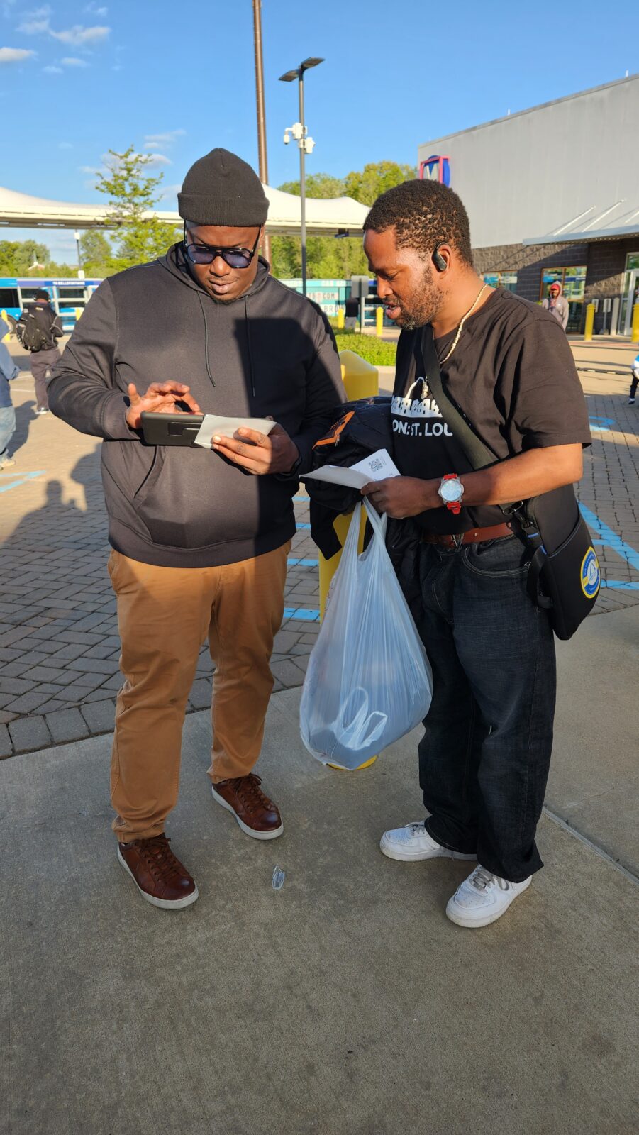 A street team member meeting with a person to get their opinion.